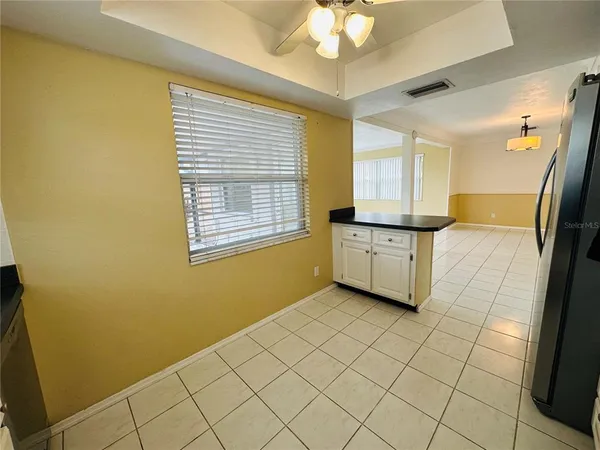 a view of a kitchen with an empty space and a window