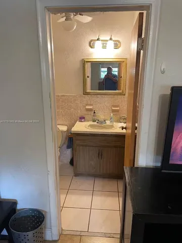 a bathroom with a sink a toilet and mirror