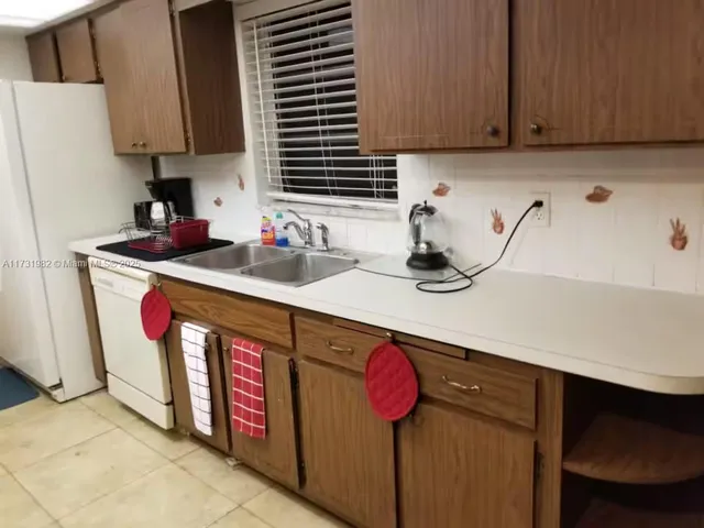 a kitchen with stainless steel appliances a sink cabinets and a counter top space
