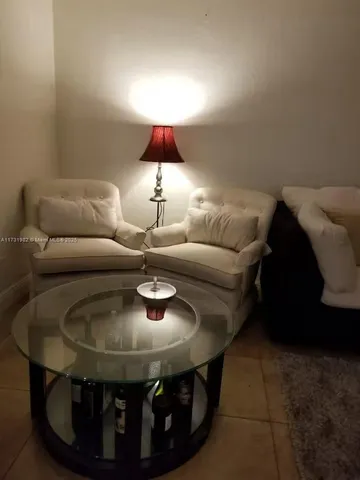 a living room with furniture and a lamp