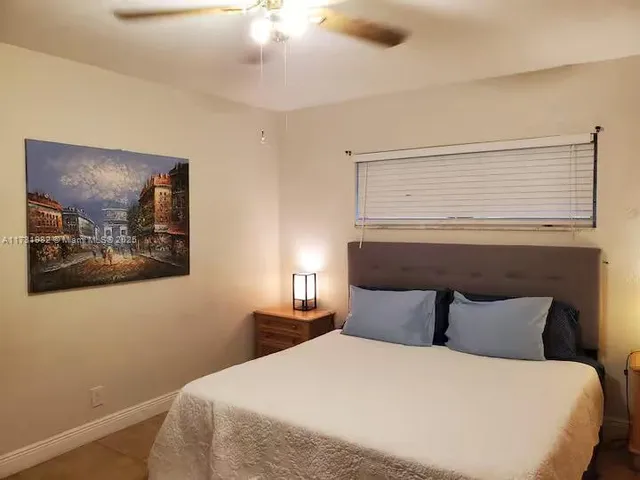 a bedroom with a bed and wall painting