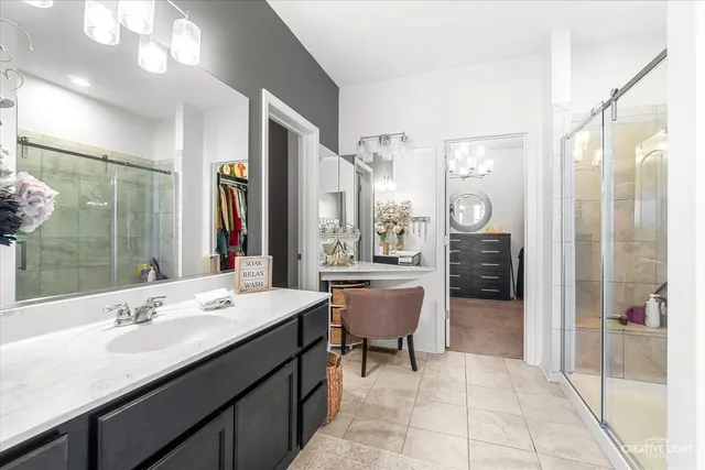 a bathroom with a sink a large mirror and a shower