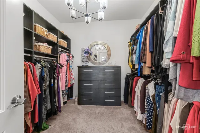 a view of walk in closet with clothes