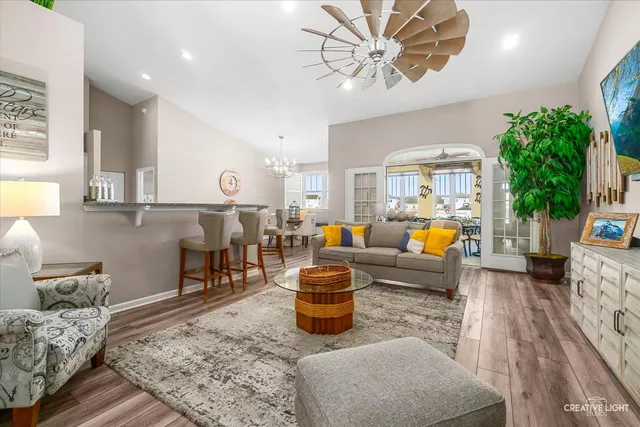 a living room with furniture and a chandelier