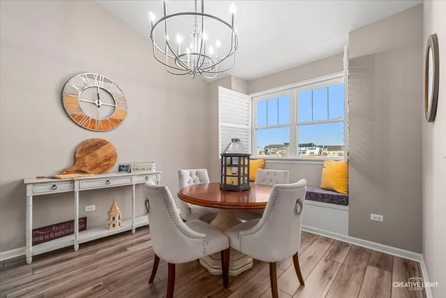 a view of a dining room with furniture wooden floor and chandelier