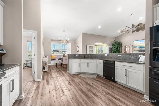 a large kitchen with a lot of counter space and a wooden floor