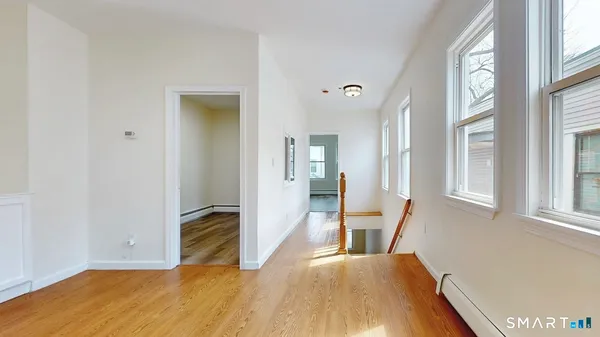 a view of a livingroom with wooden floor and a window
