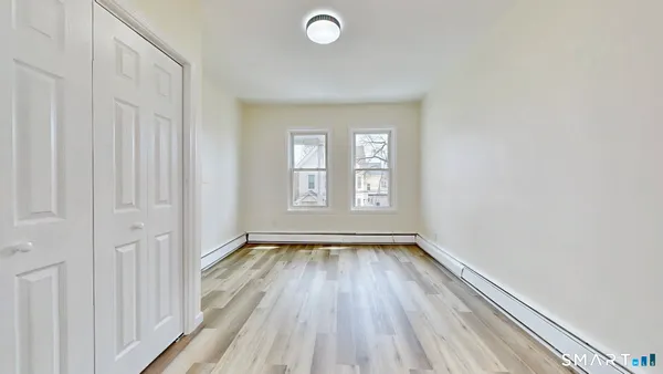wooden floor in an empty room with a window