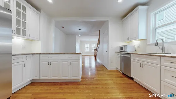 a kitchen with white cabinets