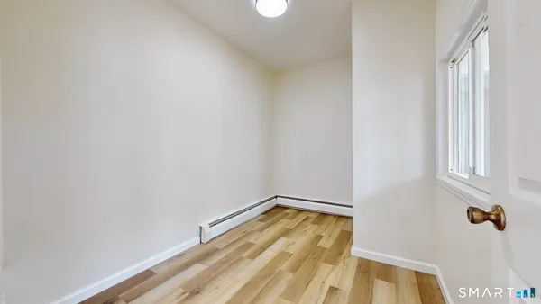 a view of a room with wooden floor and small space