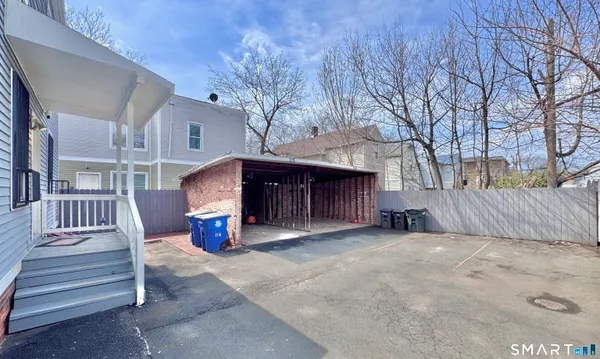 a view of a chairs and tables in the back yard of the house