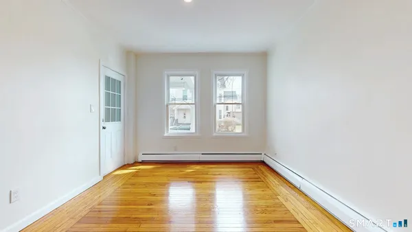 a view of bathroom with bathtub and window