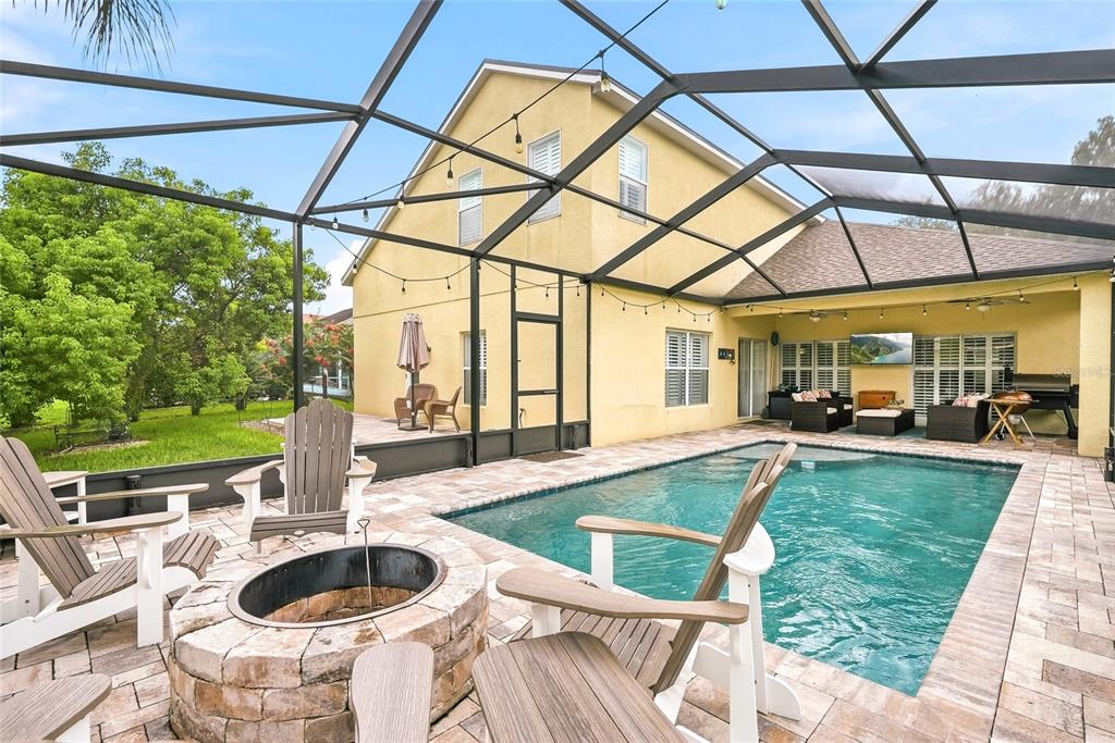16748 Midsummer Lane Spring Hill, FL 34610 - Photo 47 of 52 a view of a patio with table and chairs potted plants with wooden floor and fence