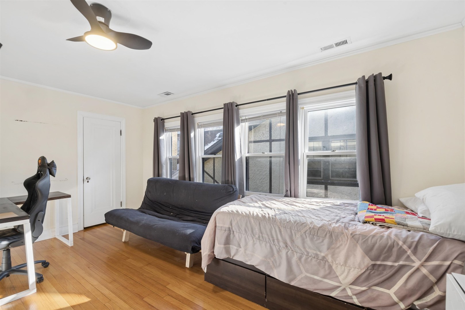 1120 Dobson Street Evanston, IL 60202 - Photo 12 of 21 a bedroom with a bed lamp and a large window