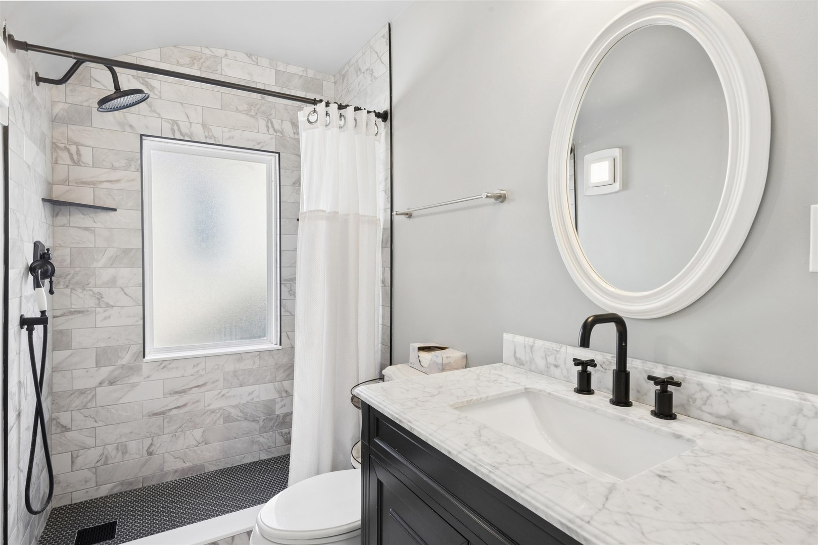 1120 Dobson Street Evanston, IL 60202 - Photo 14 of 21 a bathroom with a sink a toilet and shower