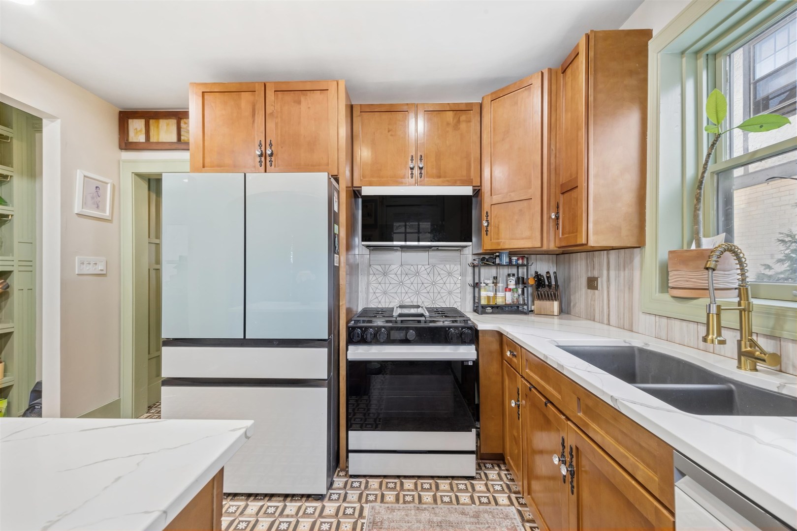 1120 Dobson Street Evanston, IL 60202 - Photo 6 of 21 a kitchen with a sink a stove and refrigerator