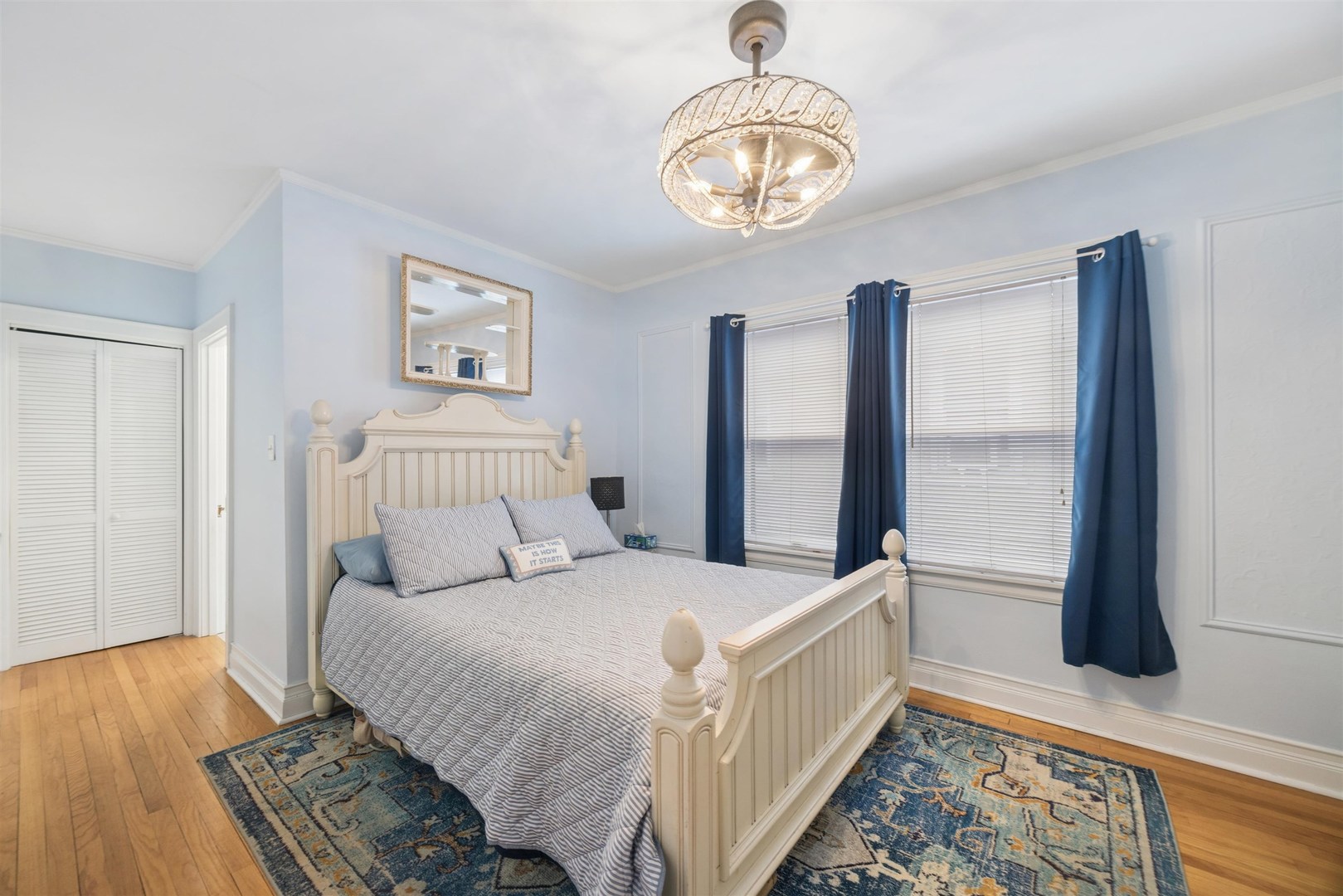 1120 Dobson Street Evanston, IL 60202 - Photo 8 of 21 a large bedroom with a bed and a chandelier