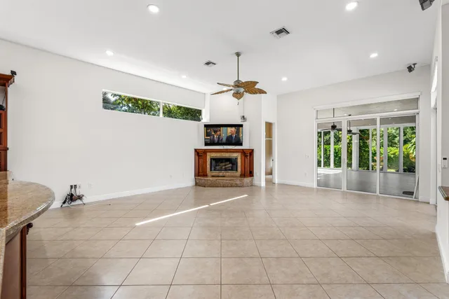 a view of a livingroom with a ceiling fan and window