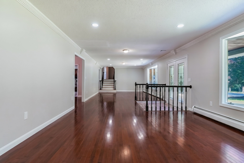 41 Watuppa Road Westport, MA 02790 - Photo 10 of 42 a view of a hallway with wooden floor and windows