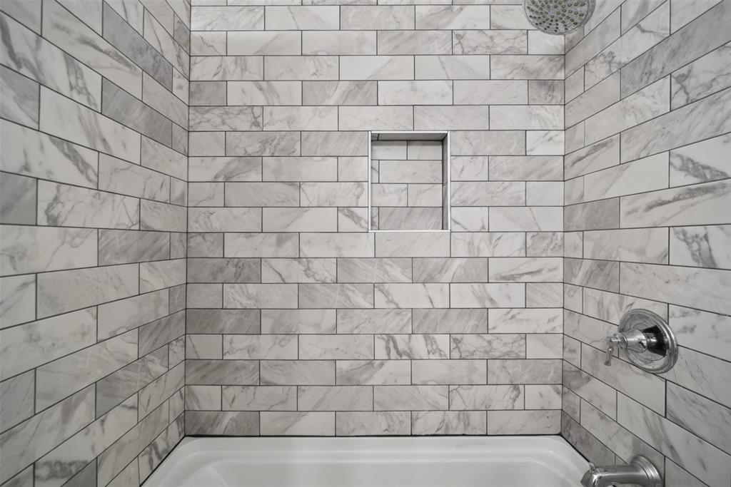 9660 Timberleaf Drive Dallas, TX 75243 - Photo 35 of 40 Subway tile surround featuring a marble-look finish, integrated shower niche, and chrome fixtures