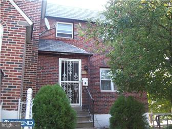 333 Wiltshire Road Upper Darby, PA 19082 - Photo 1 of 1 a view of a brick house with a large windows and flower plants