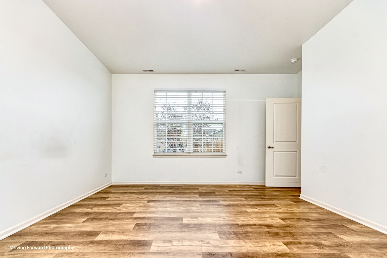 1908 Southern Circle, Unit 1908 Pingree Grove, IL 60140 - Photo 12 of 30 a view of a room with wooden floor and windows