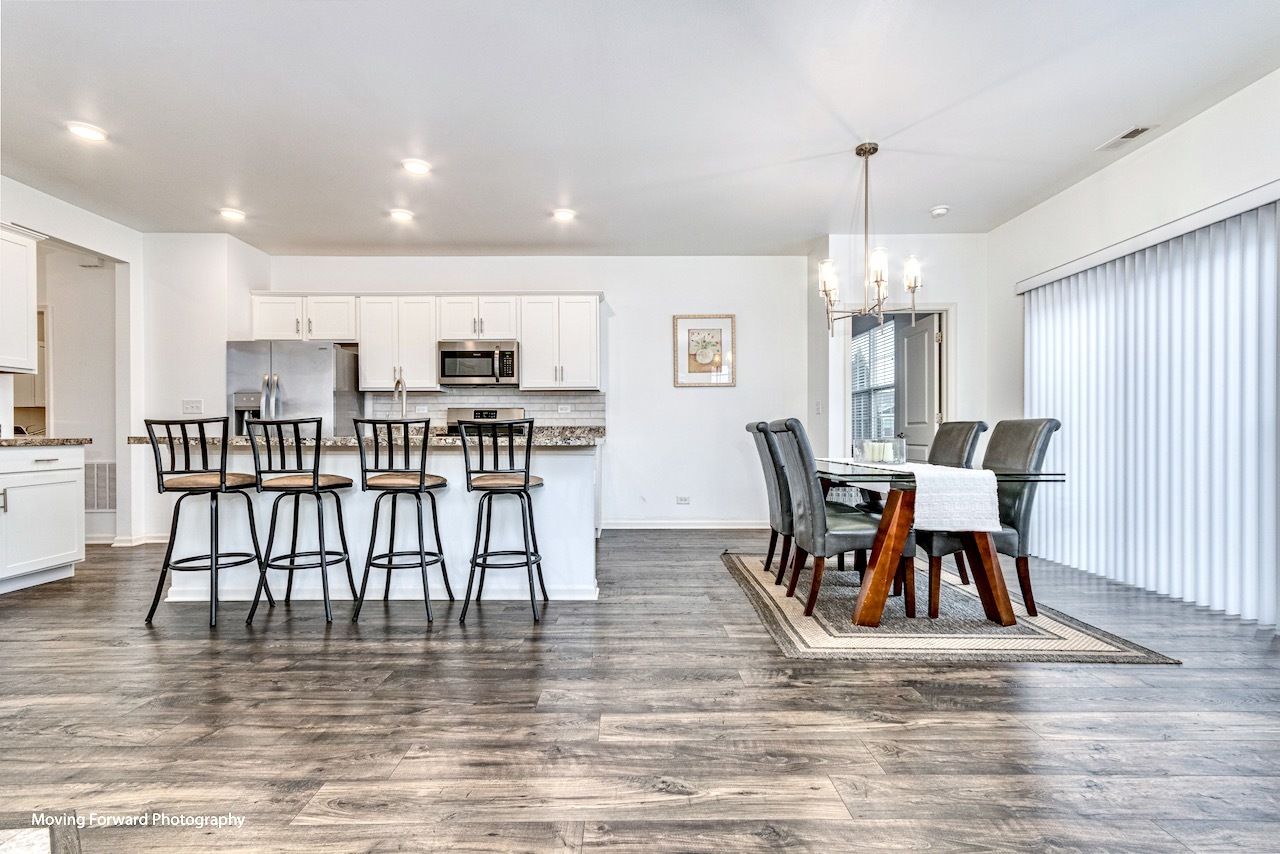 1908 Southern Circle, Unit 1908 Pingree Grove, IL 60140 - Photo 2 of 30 a view of a dining room with furniture and wooden floor
