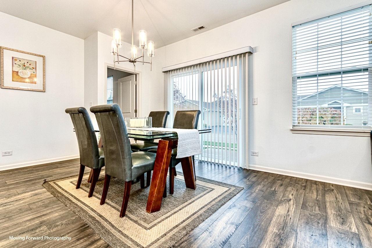 1908 Southern Circle, Unit 1908 Pingree Grove, IL 60140 - Photo 10 of 30 a view of a dining room with furniture window and wooden floor