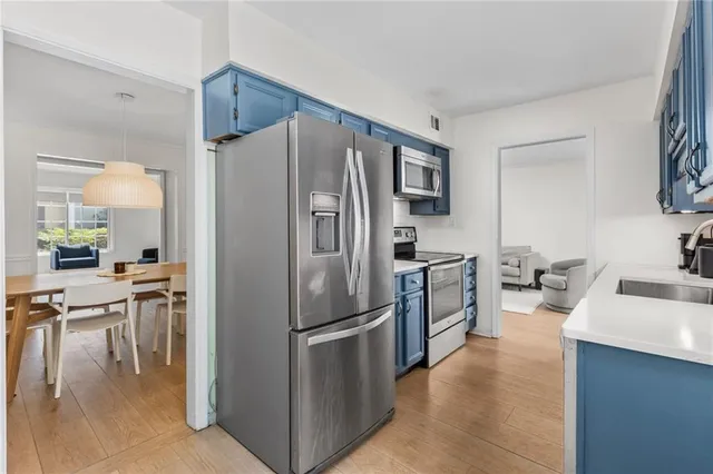 a kitchen with a refrigerator and a sink