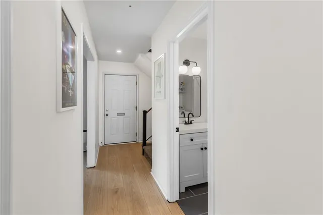 a view of a hallway with wooden floor