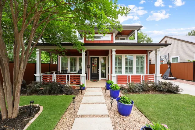 a front view of a house with a garden and plants