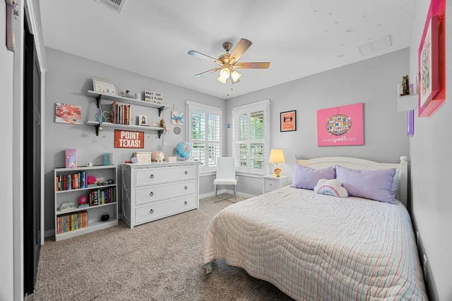 a bedroom with a bed cabinets and window