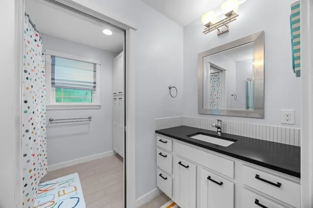 a bathroom with a sink a vanity and a mirror