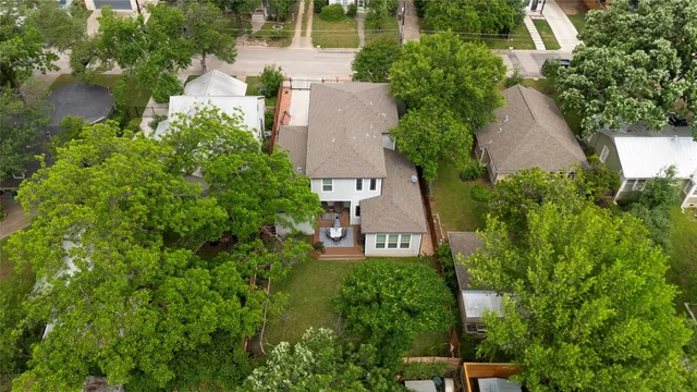 an aerial view of a house with garden space and a street view