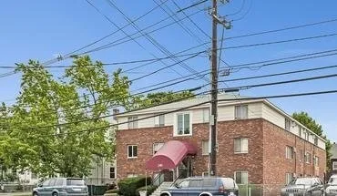 a front view of a house with plants