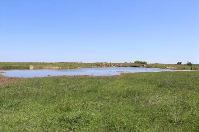 a view of a lake with houses in the back