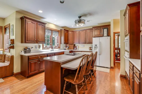a view of a hallway with wooden floor and stairs
