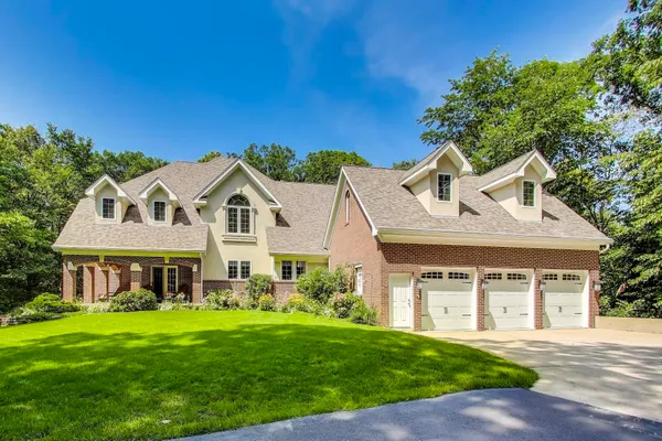 a front view of a house with a garden and porch