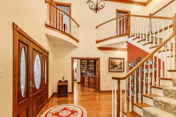a view of a dining room with furniture a chandelier and wooden floor