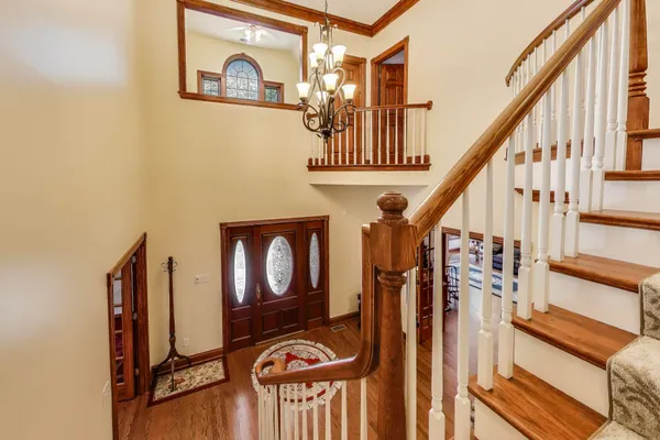 a kitchen with stainless steel appliances granite countertop a refrigerator a sink dishwasher a stove and white countertops with wooden floor