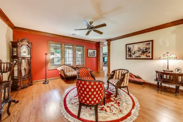 a kitchen with stainless steel appliances granite countertop a stove a refrigerator a sink dishwasher and a dining table with wooden floor