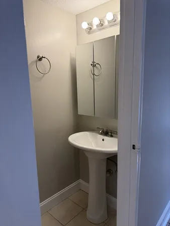 a bathroom with a sink a mirror and shower