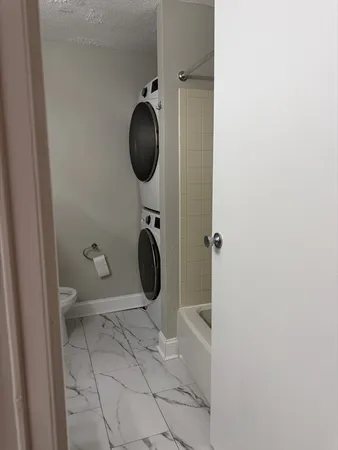 a bathroom with a toilet and a mirror