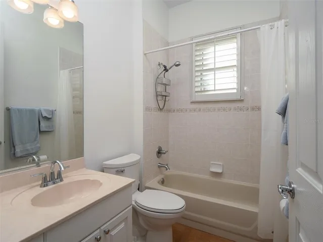 a bathroom with a sink toilet tub and shower