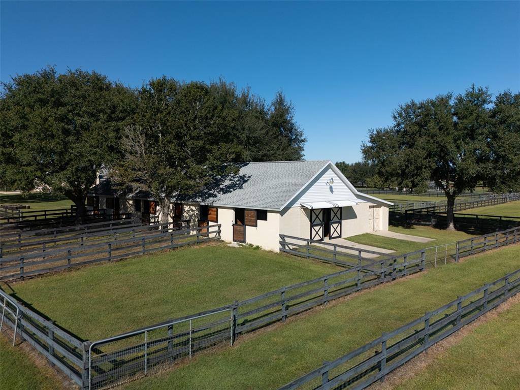 2185 Northwest 114th Loop Ocala, FL 34475 - Photo 20 of 25 a view of a white house in front of a big yard