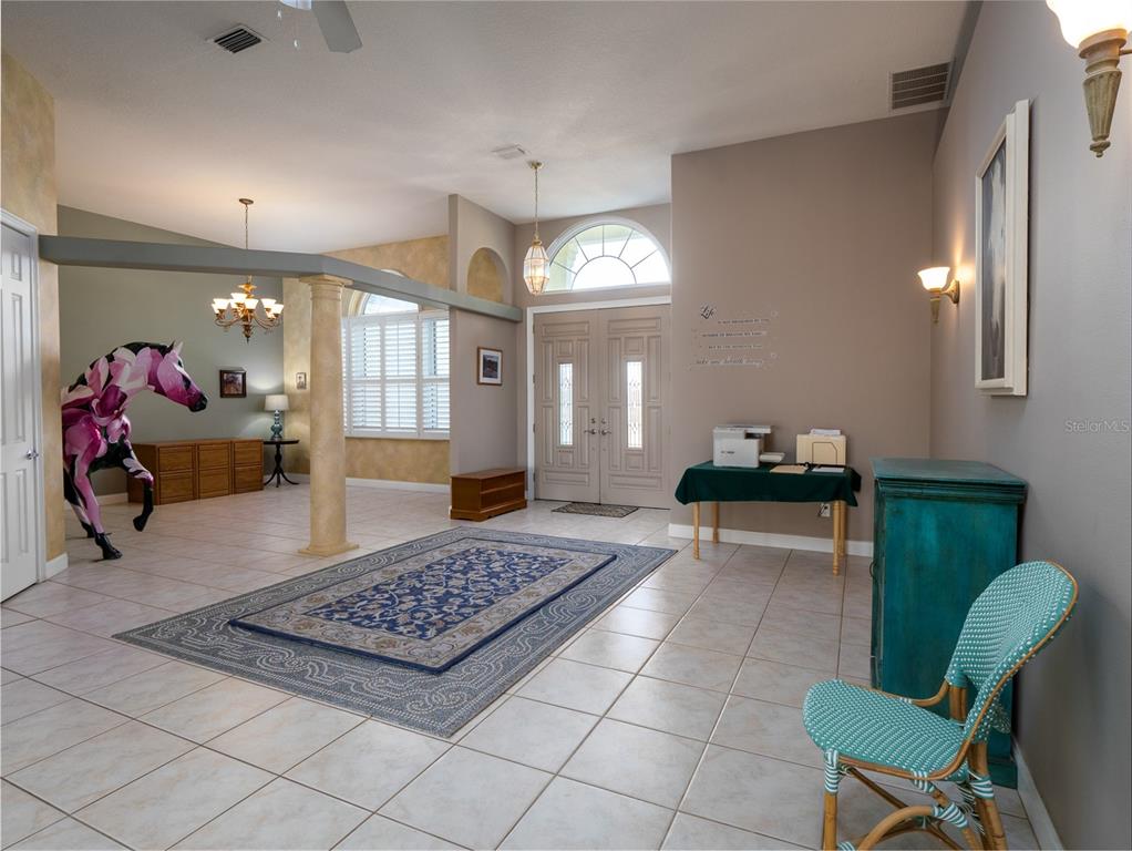 2185 Northwest 114th Loop Ocala, FL 34475 - Photo 3 of 25 a living room with furniture and a chandelier