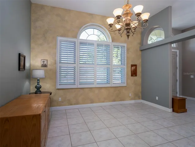 a view of a room with a chandelier and a large window