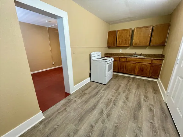 a view of a kitchen with wooden floor