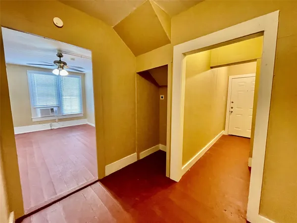 a view of a hallway with wooden floor