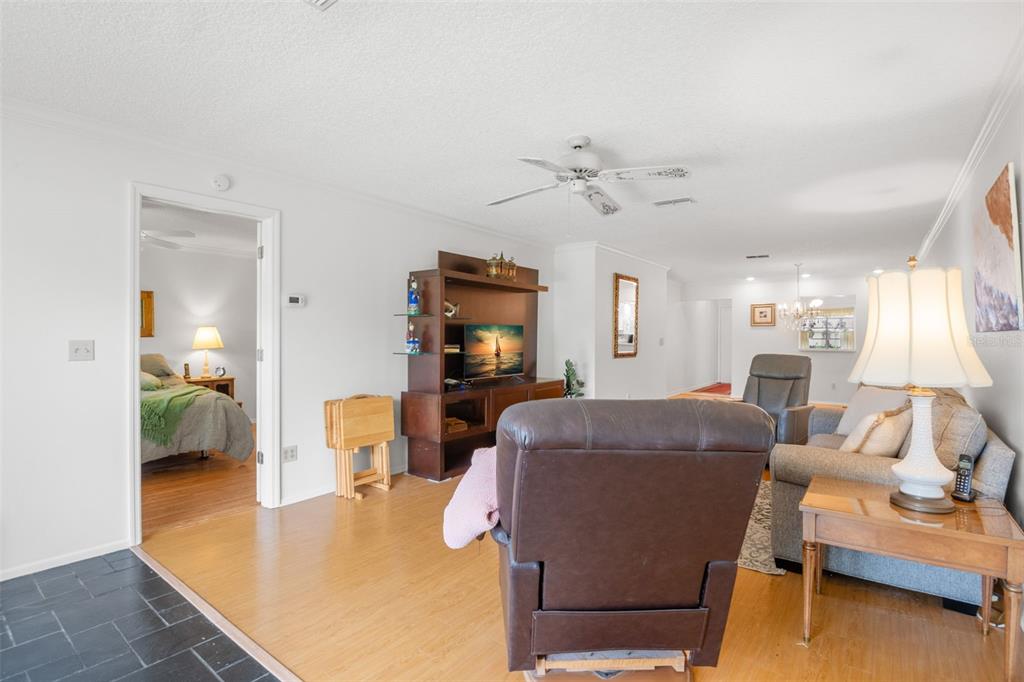 1012 Dunrobin Drive, Unit D Palm Harbor, FL 34684 - Photo 18 of 61 a living room with furniture and a chandelier